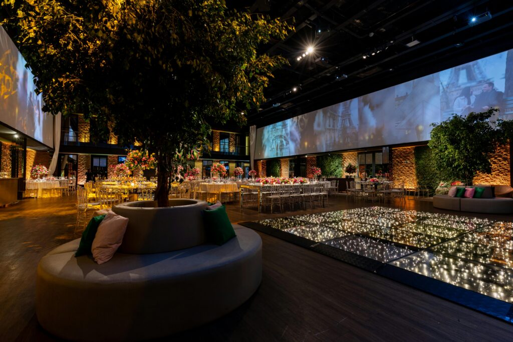 Warm Diwali lighting display illuminating an event space and courtyard tree