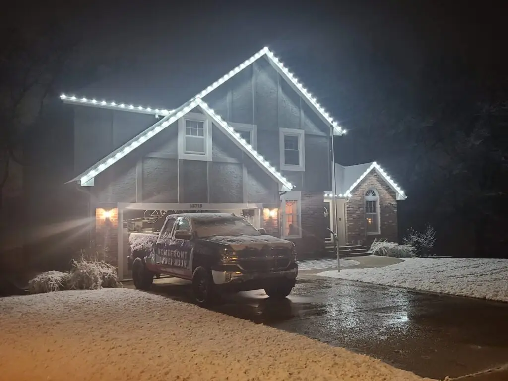 Homefront Power Wash crew installing roofline holiday lighting