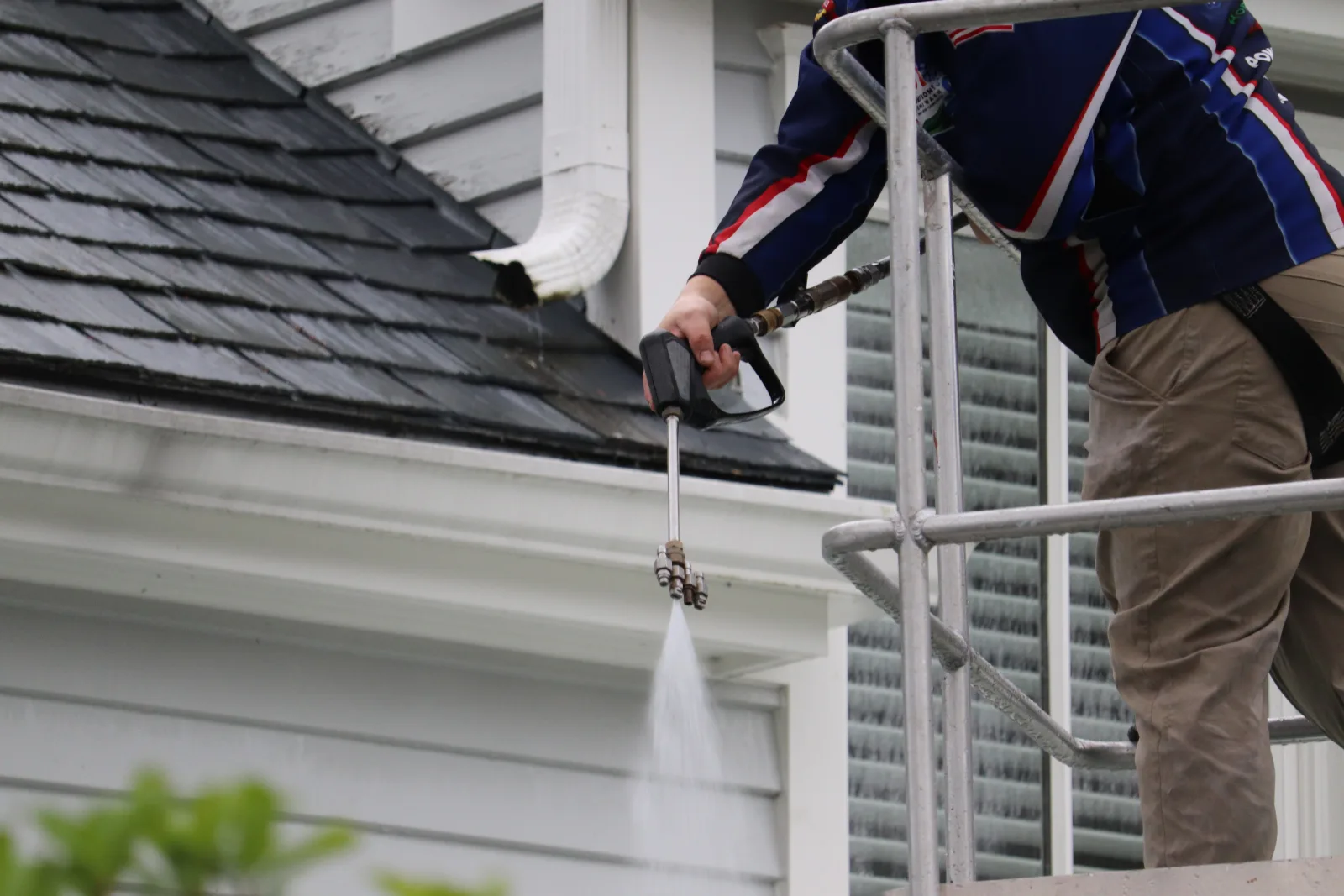Homefront Power Wash crew performing a soft wash roof cleaning (verify)