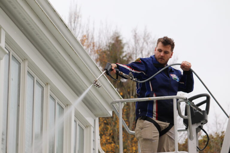 Dillon, owner of Homefront Power Wash, power washing a beautiful home in Medina/Bellevue, WA