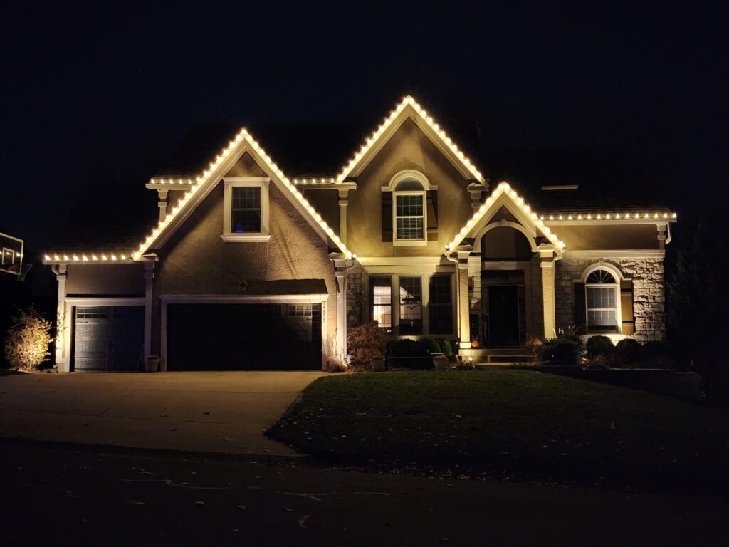 Homefront Holiday Lights shining bright during the night on a beautiful house in the Seattle/Eastside Area