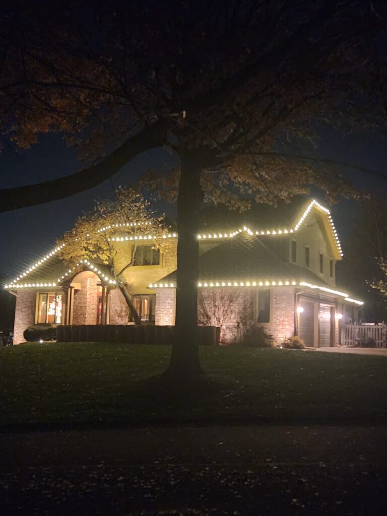 Homefront Holiday Lights shining bright during the night on a beautiful house in the Seattle/Eastside Area