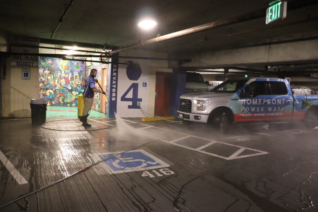 Chris Berry from Homefront Power Wash power washing the parking lot at Pike Place Market in Seattle, WA